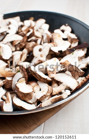 Cooking mushrooms in frying pan vertical