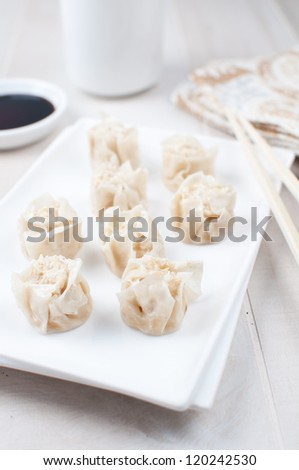 Chinese dumplings eating with chop sticks vertical