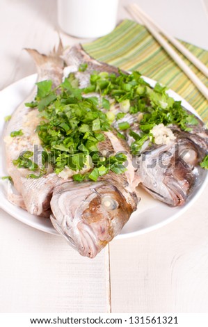 Steamed fish whole with green onions and ginger