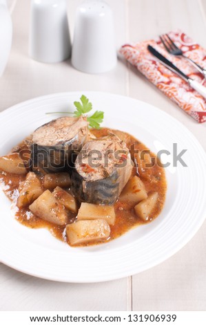 Pieces of stewed mackerel with vegetable stew vertical
