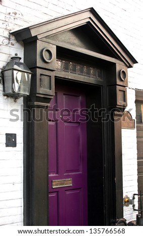 Old house door painted in bright purple color