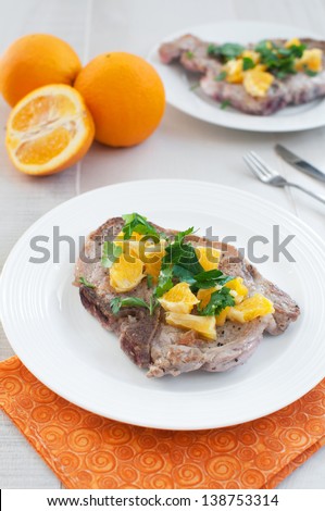 Fried pork meat with citrus salsa above