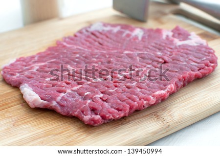 Beef eye round steak piece on cutting board