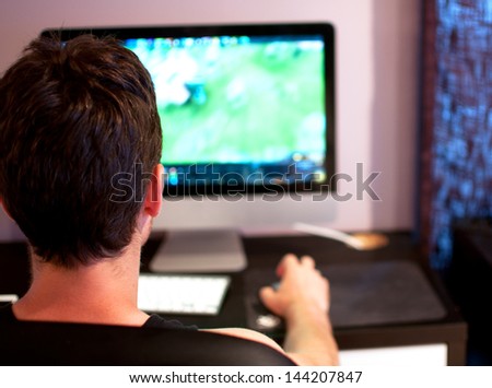 Young Man Playing Computer Game Back Of The Head View