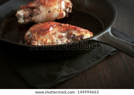 Fried turkey leg in cast iron pan
