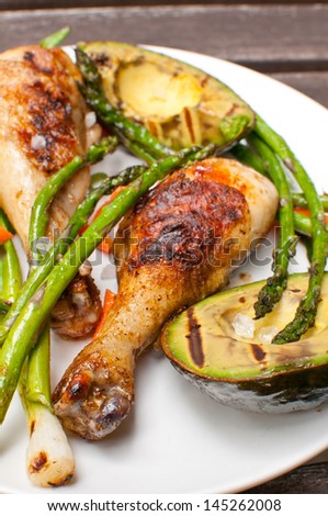 Grilled chicken drumsticks with asparagus and avocado