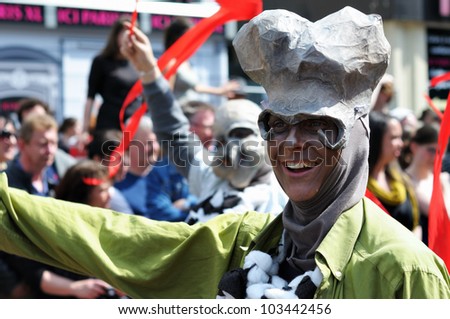 BRUSSELS, BELGIUM-MAY 19: An unknown participant in weird costume greets people during Zinneke Parade on May 19, 2012 in Brussels. This parade is a biennial urban artistic and free-attendance event.