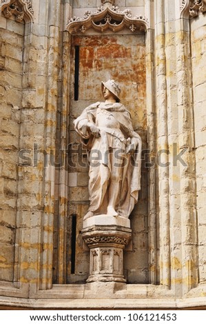 Statue of a knight in medieval costume on the wall of Petite Sablon church in Brussels