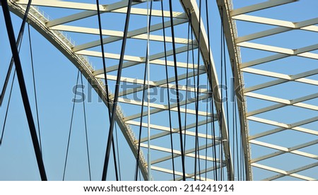 View inside of a modern metal bridge with blue sky as a construction background image