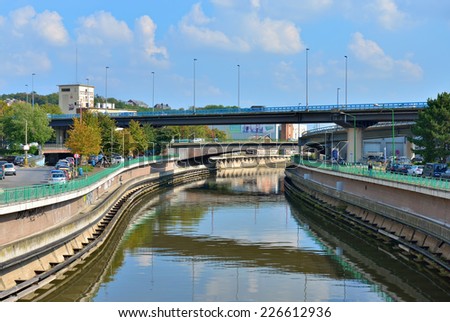 CHARLEROI, BELGIUM-OCTOBER 03, 2014: La Sambre river cross the city in business and industrial districts with intensive traffic on streets