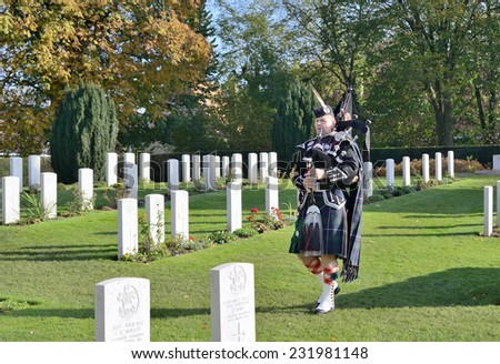 YPRES, BELGIUM-NOVEMBER 11, 2014: Commemoration ceremony at Ramparts cemetery on Armistice Day. 198 graves of soldiers of First World War 1914-1918