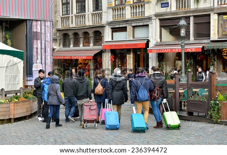 BRUSSELS, BELGIUM-DECEMBER 8, 2014: Leaving Brussels tourists came back one time again to see Grand Place
