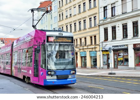 LEIPZIG, GERMANY-DECEMBER 21, 2014: Tram moves through central part of Leipzig. Trams often used for advertisement exposure in the city