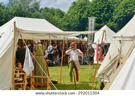 DEURNE, BELGIUM-JUNE 13, 2015: Participants of reconstruction of medieval battle of 1477 in medieval clothes in camping of knights