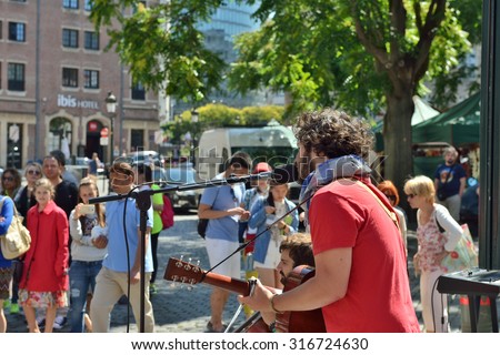 BRUSSELS, BELGIUM, JULY 10, 2015: Street musician gives concert on the street in historical center of Brussels