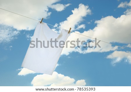 Fresh washed kitchen white towel drying on the wind in cloudy day