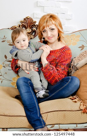 Nice family picture of a mother sitting with her son on a couch