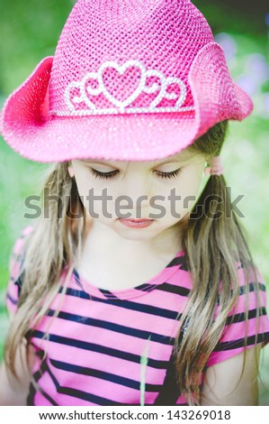 Little smiling cowgirl outdoors