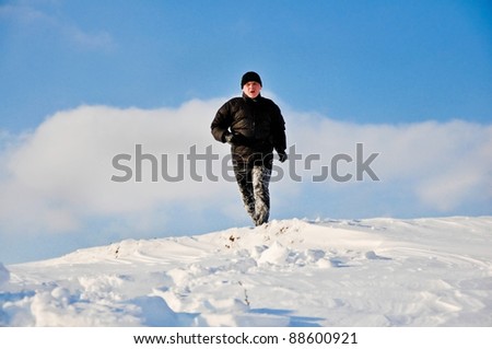 Man running in the snow field