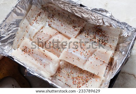 Atlantic cod fresh raw fish fillet with herbs, elevate view