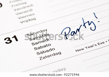 Calendar opened on new year\'s eve date. Blue ink handwritten party note.