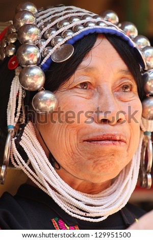 CHIANG RAI, THAILAND - FEB 26 : Akha hill tribe with traditional clothes and silver jewelery in akha hill tribe minority village on February 26, 2013 in Chiang Rai, Thailand.
