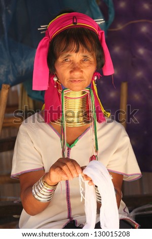 CHIANG RAI, THAILAND - FEB 26 : Karen long neck hill tribe with traditional clothes and silver jewelery in  hill tribe minority village on February 26, 2013 in Chiang Rai, Thailand.