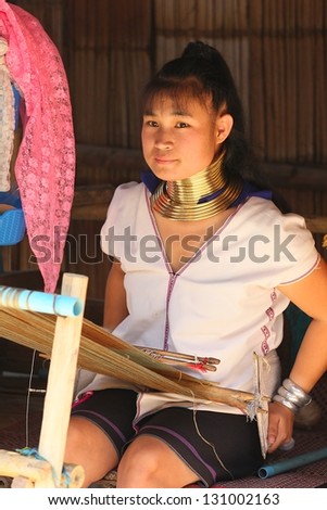 CHIANG RAI, THAILAND - FEB 26 : Karen long neck hill tribe with traditional clothes and silver jewelery in hill tribe minority village on February 26, 2013 in Chiang Rai, Thailand