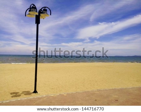 Street lighting on the beach with the blue sky