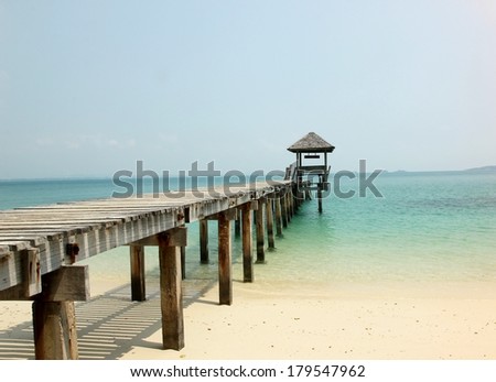 a wooden bridge leading to a wooden pavilion over the sea at Koh Samet island Thailand