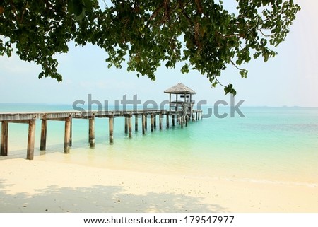 a wooden bridge leading to a wooden pavilion over the sea at Koh Samet island Thailand