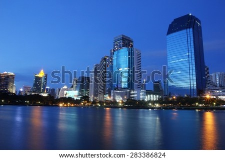 BANGKOK, THAILAND-JUNE 01 : Business area and hotel is in Bangkok city downtown at night time with reflection on wide lake in Bangkok, Thailand June 01, 2015