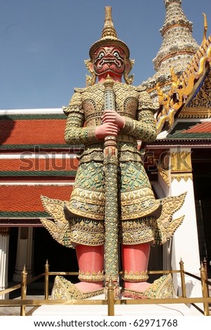 Thai demon statue in front of the temple gate.
