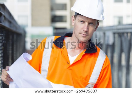 Construction worker with helmet working outdoor at a building site for a new road
