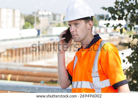 Construction worker with helmet working outdoor at a building site for a new road