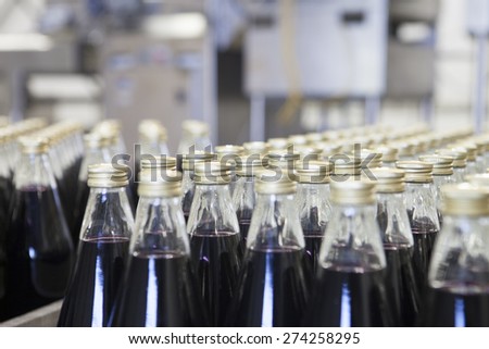 Rows of packed bottles in factory