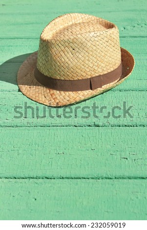 Men\'s straw hat, lying on an old wooden table