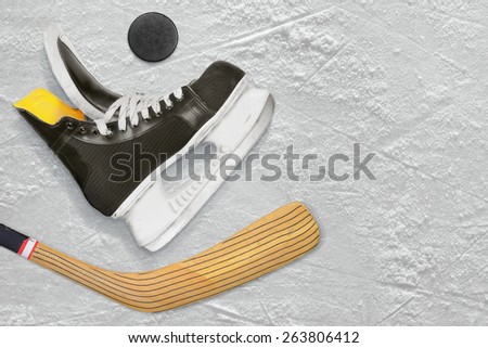 Hockey skates, stick and puck on the ice. Texture, background