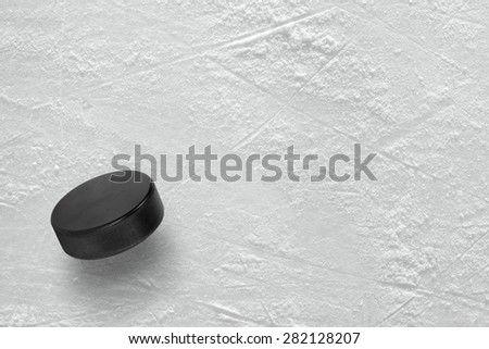 Hockey puck on the ice arena. Texture, background