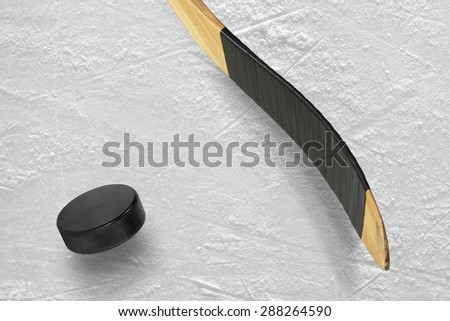 Hockey puck and stick on the ice arena. Texture, background