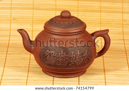 Chinese teapot for brewing tea standing on the mat