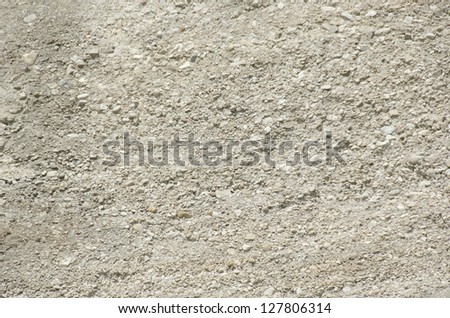 background of sandy limestone in sunlight with small and big stones