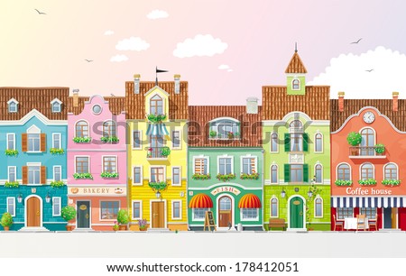 Old historical houses shops and cafe at the city street with summer trees and flowers Old historical houses shops and cafe at the city street with summer trees and flowers