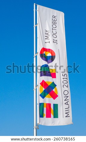 MILAN, ITALY, MARCH 11. A giant flag banner with the logo of the 2015 international Expo fair about food hosted in Milan, with blue sky and copy space, taken on 11 March 2015.