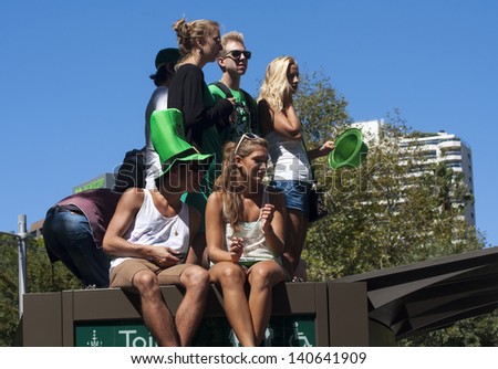 SYDNEY, AUSTRALIA - MAR 17TH: Watching the  St Patrick\'s Day parade on March 17th 2013. Australia has marked the occasion since 1810