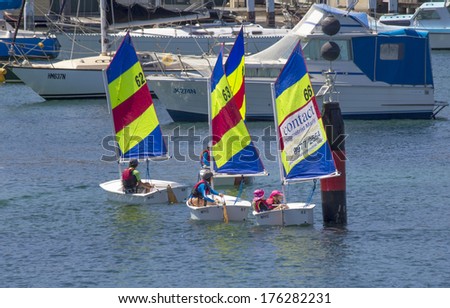 MANLY, AUSTRALIA-DECEMBER 19TH 2013: Children learning the basics of sailing in dinghies in Manly harbour. Sailing is a very popular sport in Australia.