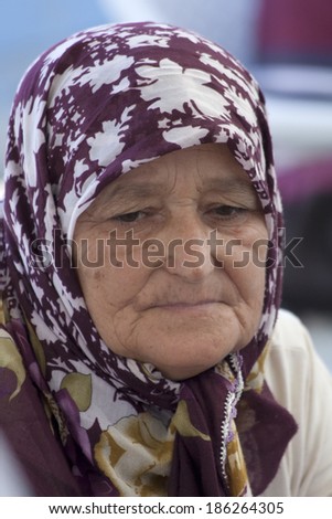 Alanya, Turkey-September 20th 2011: A Turkish woman shopping on the market wearing a traditional headscarf.  The wearing of headscarves by women in public institutions was banned until October 2013.