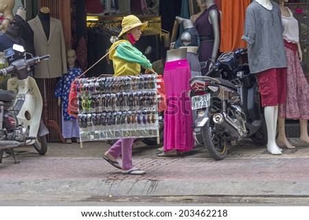 HO CHI MINH CITY,VIETNAM-NOV 4TH 2013: A street vendor selling sunglasses. Street vendors are a common sight in the city.