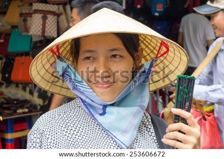 Ho Chi Minh City, Vietnam-29th Oct 2013: Woman street vendor selling fans. Street vendors can be found all over the city.