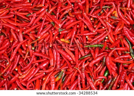 Pile of hot red chillies on a market stall in Bangkok, Thailand. mage by Kevin Helllon.